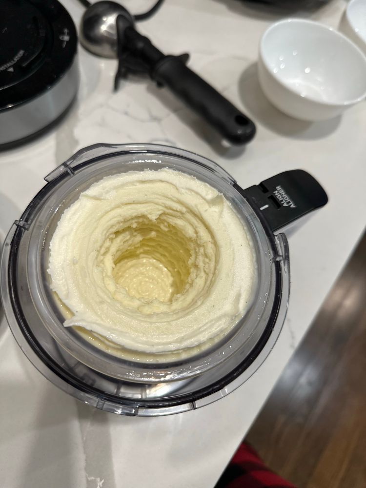 ninja creami pint of vanilla ice cream with a cylinder-like indent in the center because of the mixer (kinda sus)