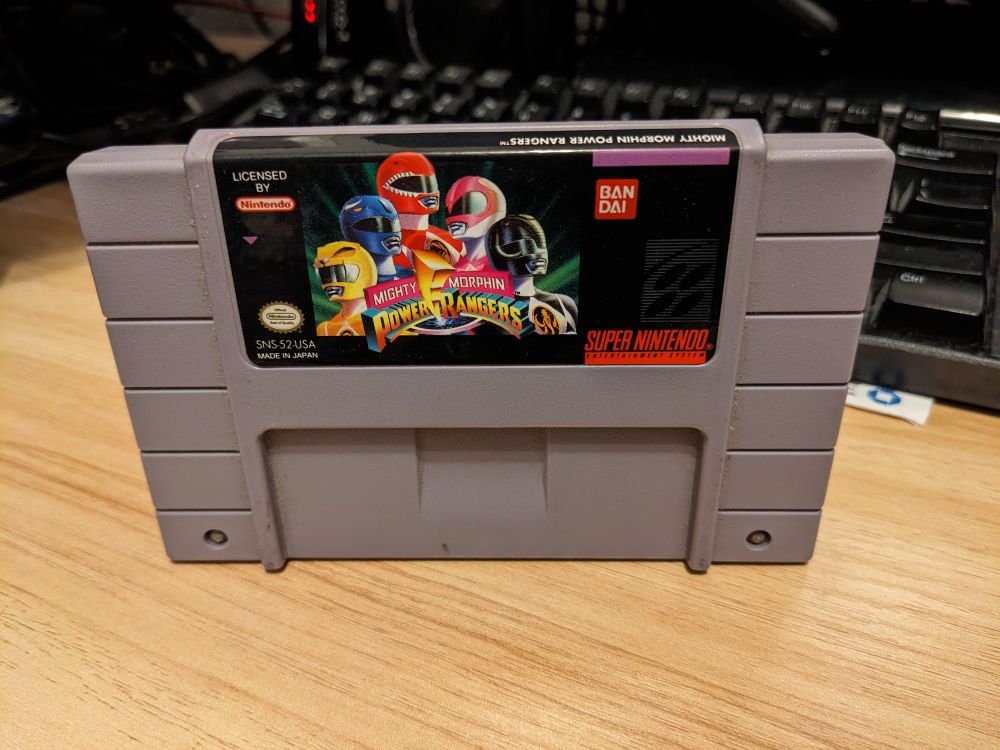A loose cartridge of Mighty Morphin Power Rangers, for the Super NES 
