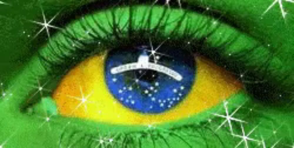 a close up of a woman 's eye with the brazilian flag painted in it