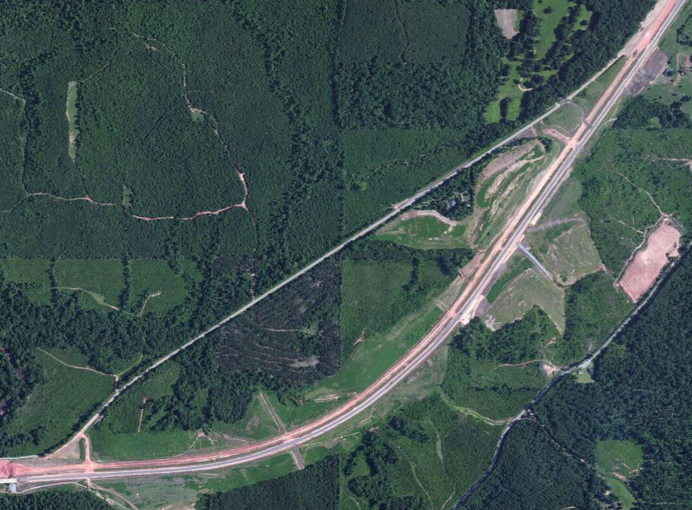 Picture of a section of 2 lane road being bypassed by a 4 lane road.