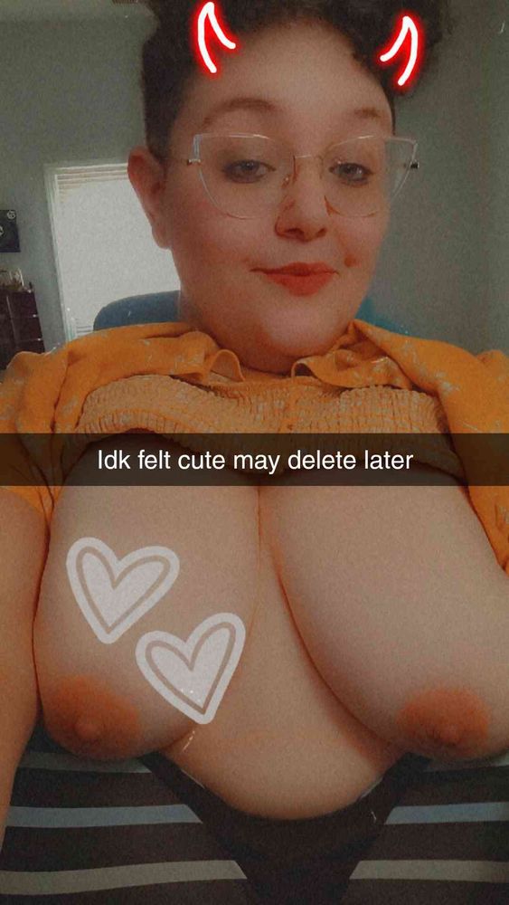 Thistle's tits are out with an IDK felt cute may delete later, hearts, and devil horns Snapchat filter