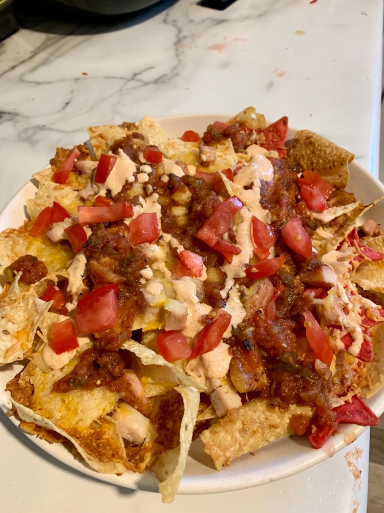 Finished product with salsa, red jalapeño crema, and fresh diced tomato