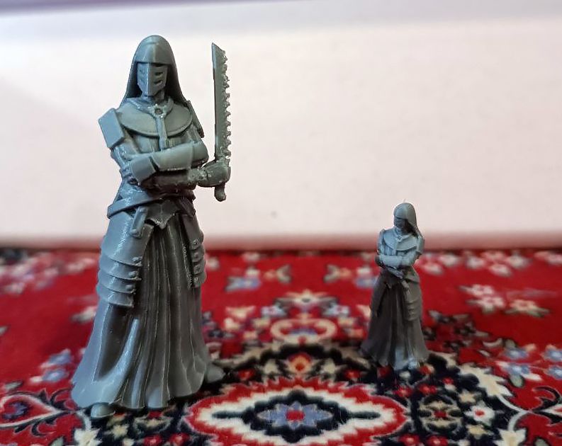 Two 3d printed "Combat Medic" miniatures from Trench Crusade. One is twice as large as the other
