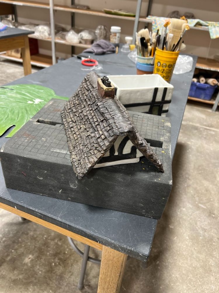 This image is of the "lid"  the roof of the ceramic house on a cushion while it was being worked on