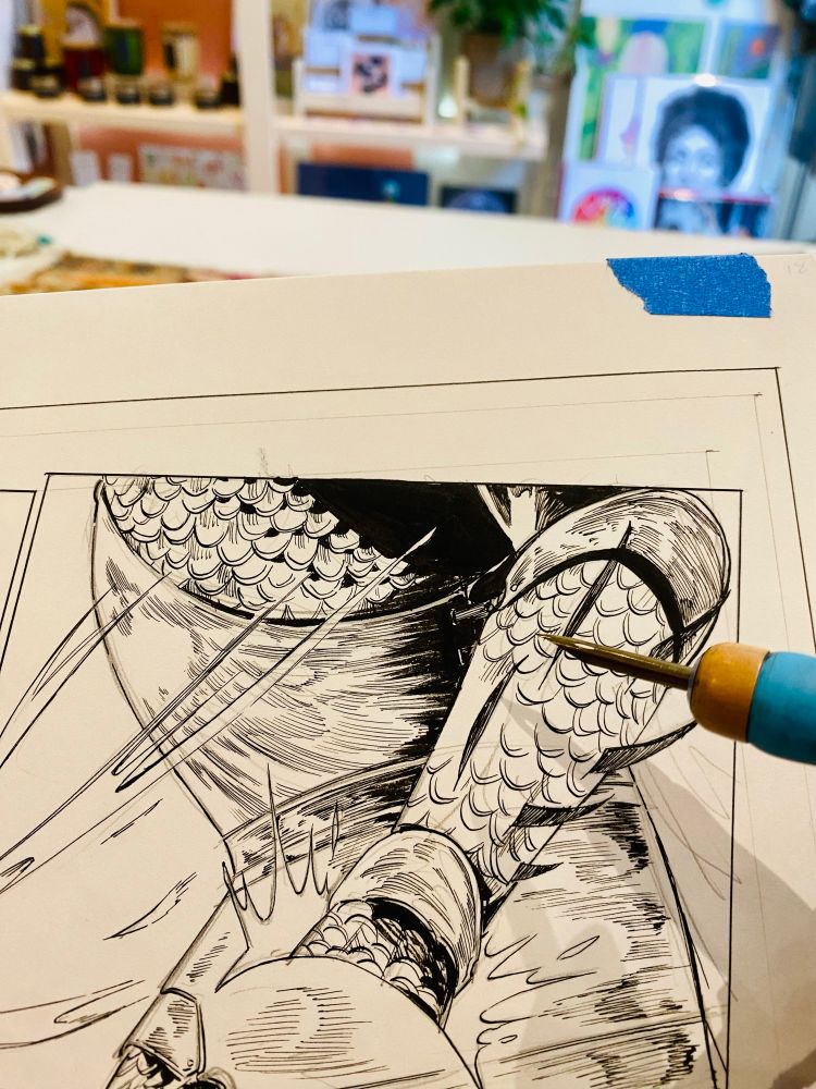A pic of me inking a comic panel at my work behind the register 