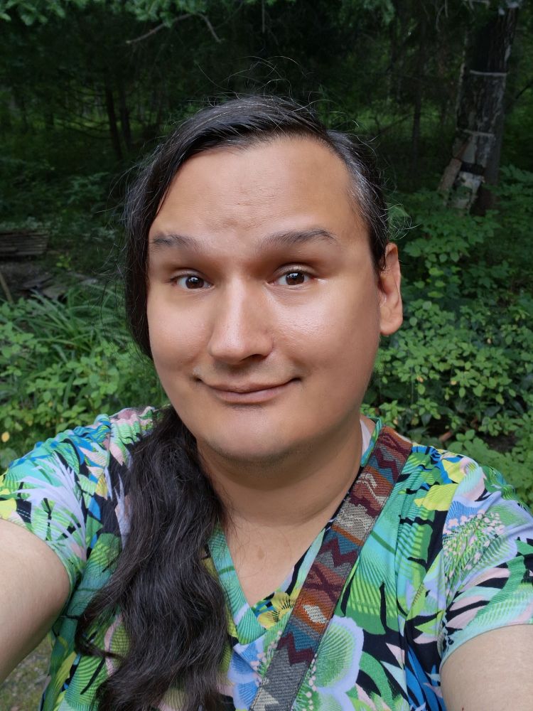 Selfie of me. I'm wearing a foresty-like tunic while in the woods during daytime.