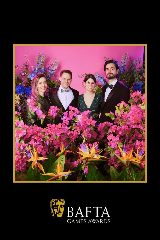 The Botany Manor team members standing in between flowers