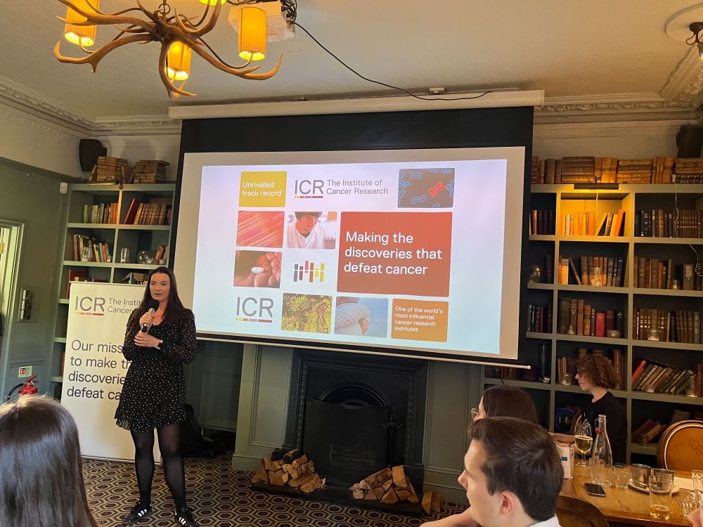 Presenting in the pub at Pint of Science. The ICR's branding is on the slide projected in the background.