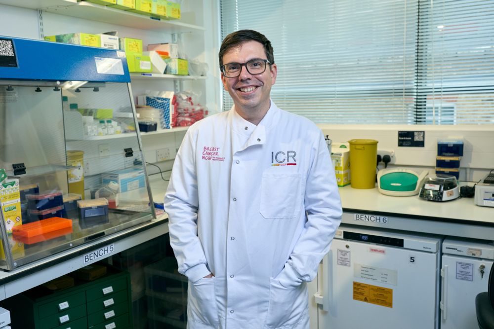 Dr Stephen-John Sammut pictured in his lab with a lab coat on.