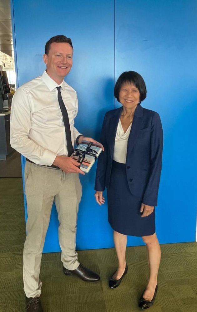 Mayor Chow presents Seb with a book about the history of cycling in Toronto