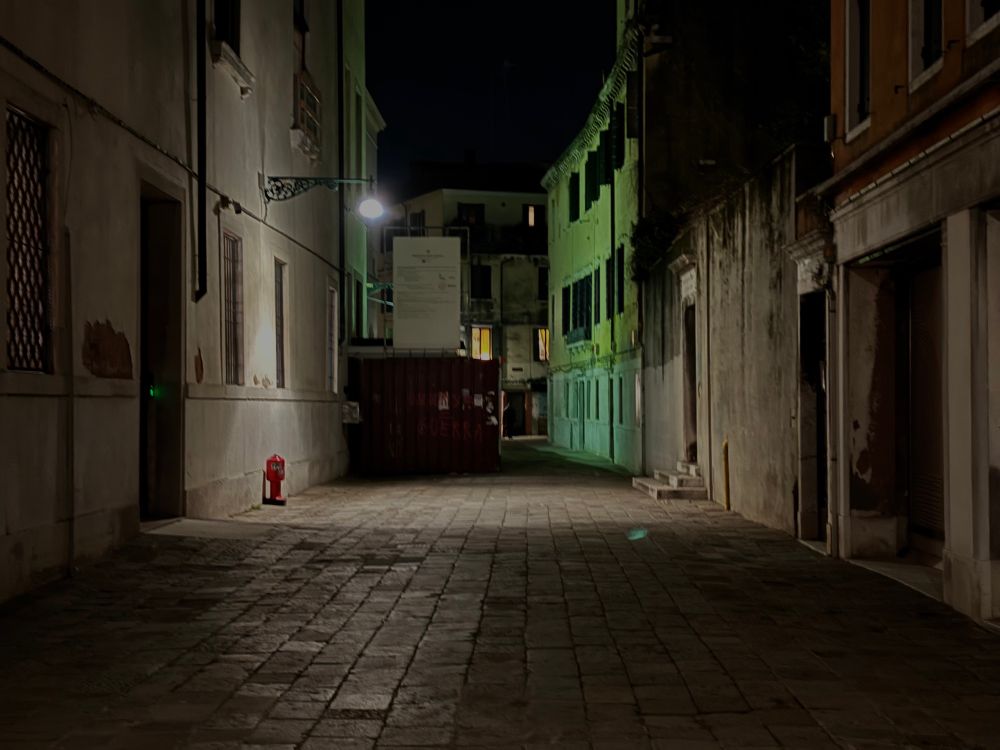 A dark Venetian calle, with fire hydrant