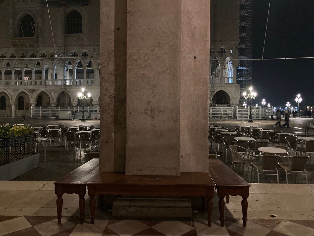 Benches set around a column of the Procuratie Nuove, in front of Florian, looking out to Piazza San Marco