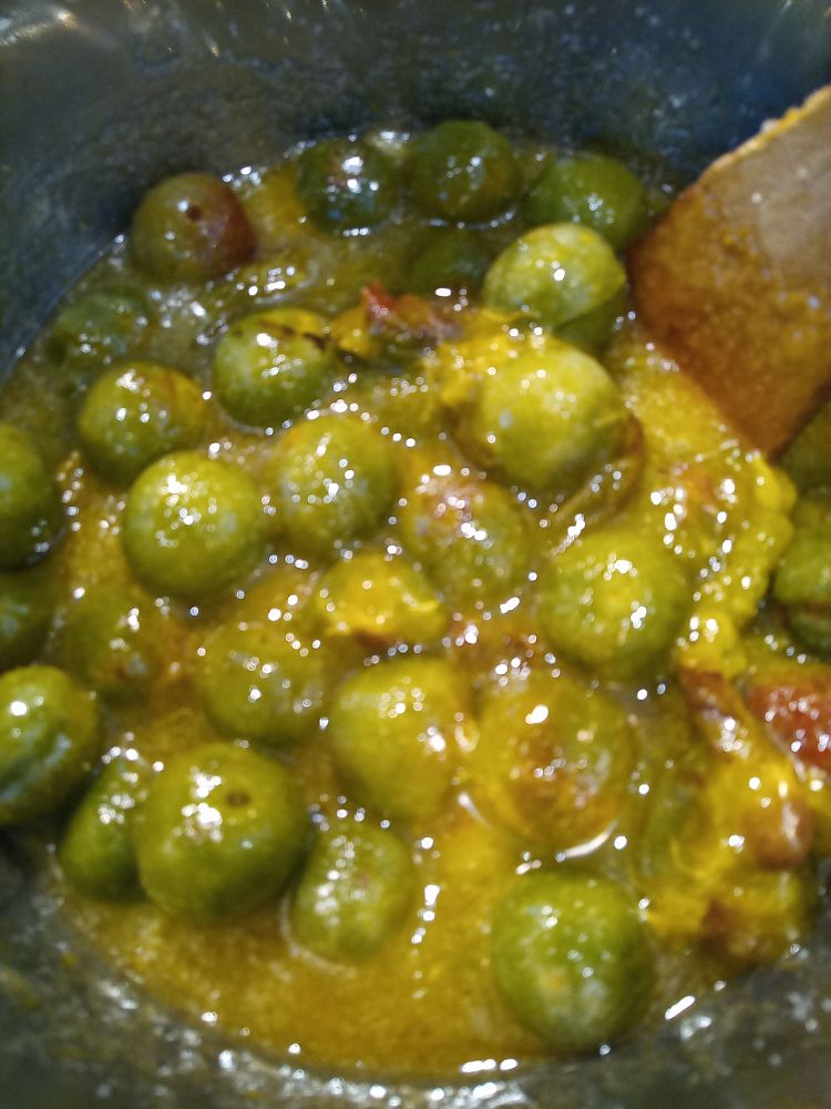 A pan full of greengages just starting to boil for jam.