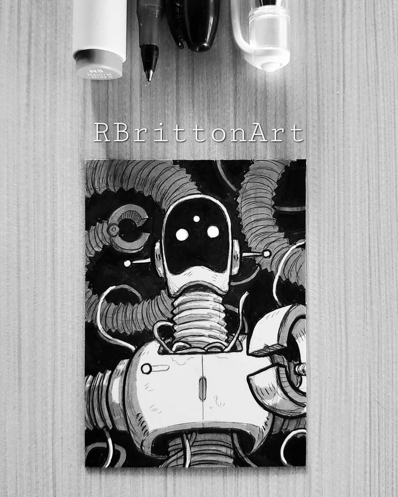 A photograph of an artist trading card drawing, sitting on a table straight on. There are pens positioned above the piece that show the tools used to create the art. This card has a drawing of a robot bust drawing. The bg is pitch black. The drawing details are white with grey shading. Two antenna jut from the side of it's face. It has three beady white eyes with a black screen face. It's arms coil up everywhere all over the piece.
A photograph of an artist trading card drawing, sitting on a table straight on. There are pens positioned above the piece that show the tools used to create the art. This card has a drawing of a robot bust drawing. The bg is pitch black. The drawing details are white with grey shading. Two antenna jut from the side of it's face. It has three beady white eyes with a black screen face. It's arms coil up everywhere all over the piece.