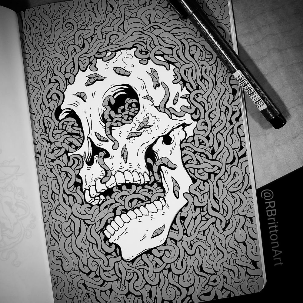 a traditional art piece of a skull submerged in worms. 
