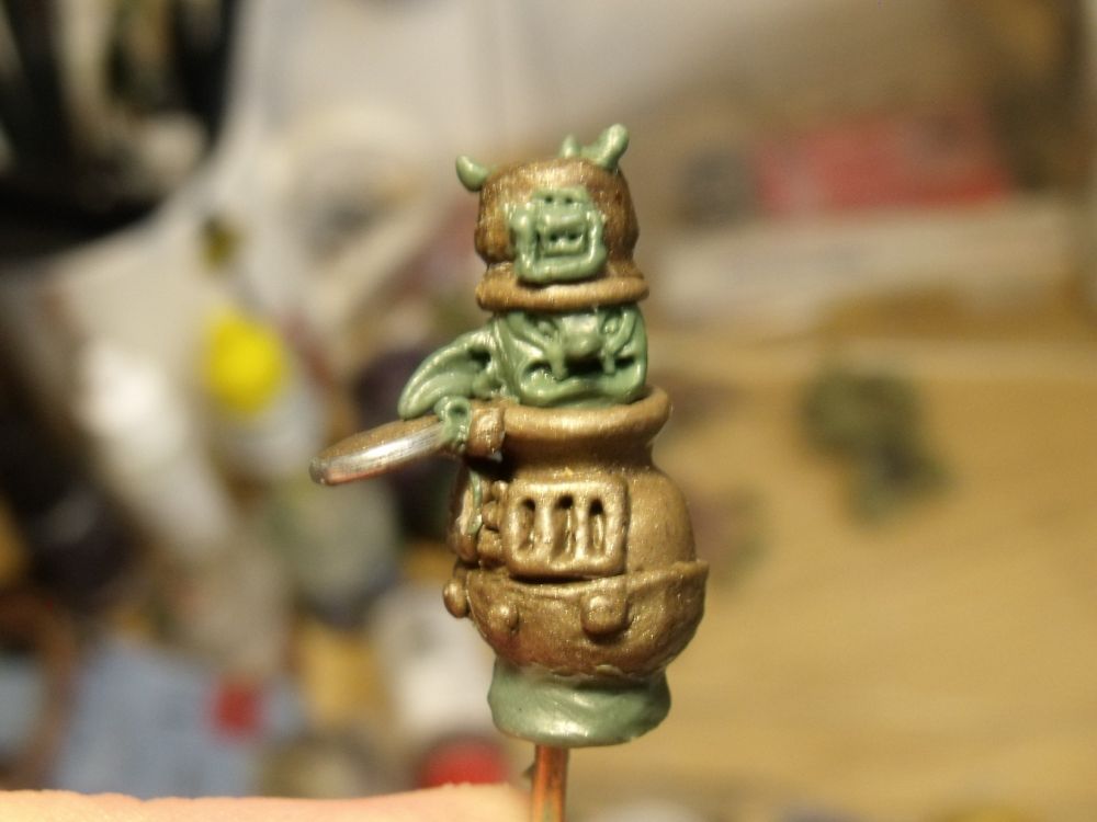 unfinished goblin wearing a pot as a hat and living inside a stove