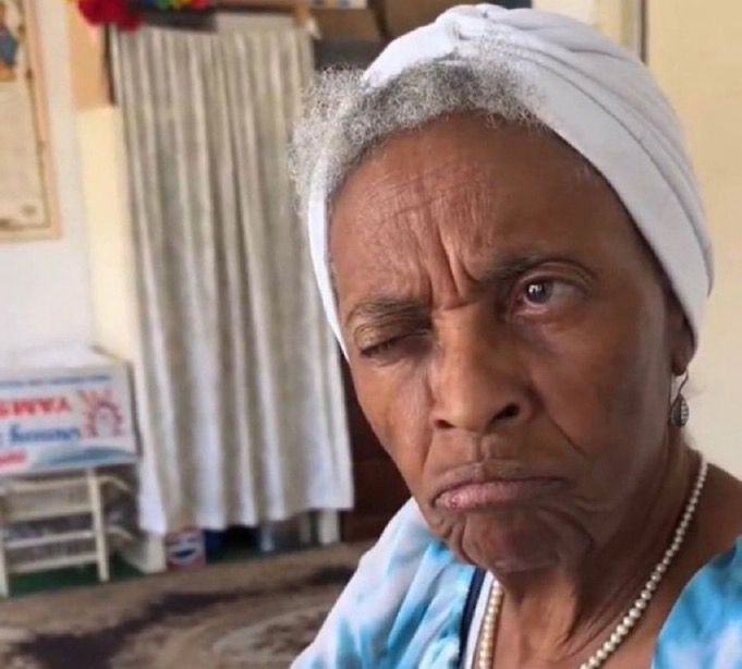 Old blank woman thinking with one eye closed 