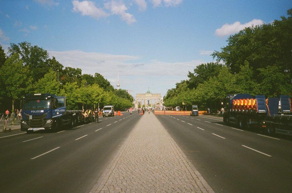 the brandenburg gate, flanked by two empty roads
