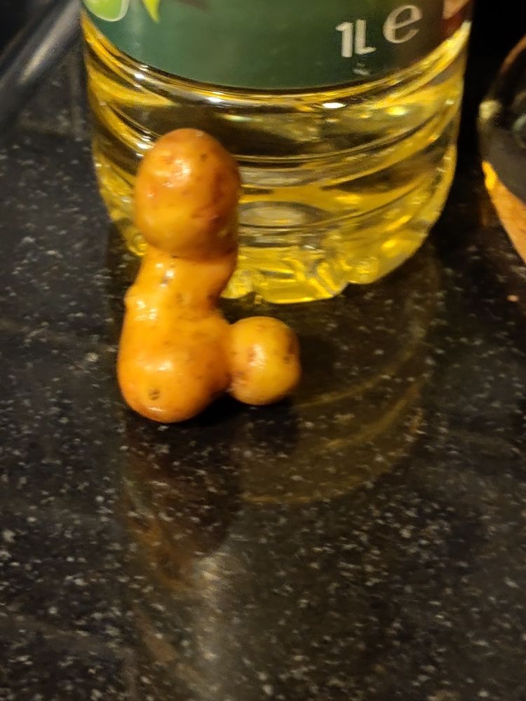 Pink fir apple potato with protuberances which resemble, well, a protuberance.