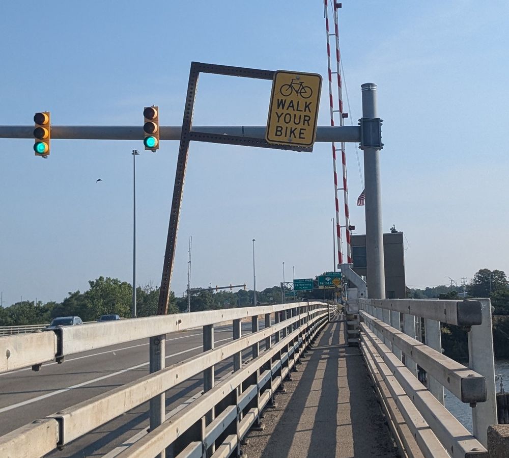 walk your bike sign on a bridge