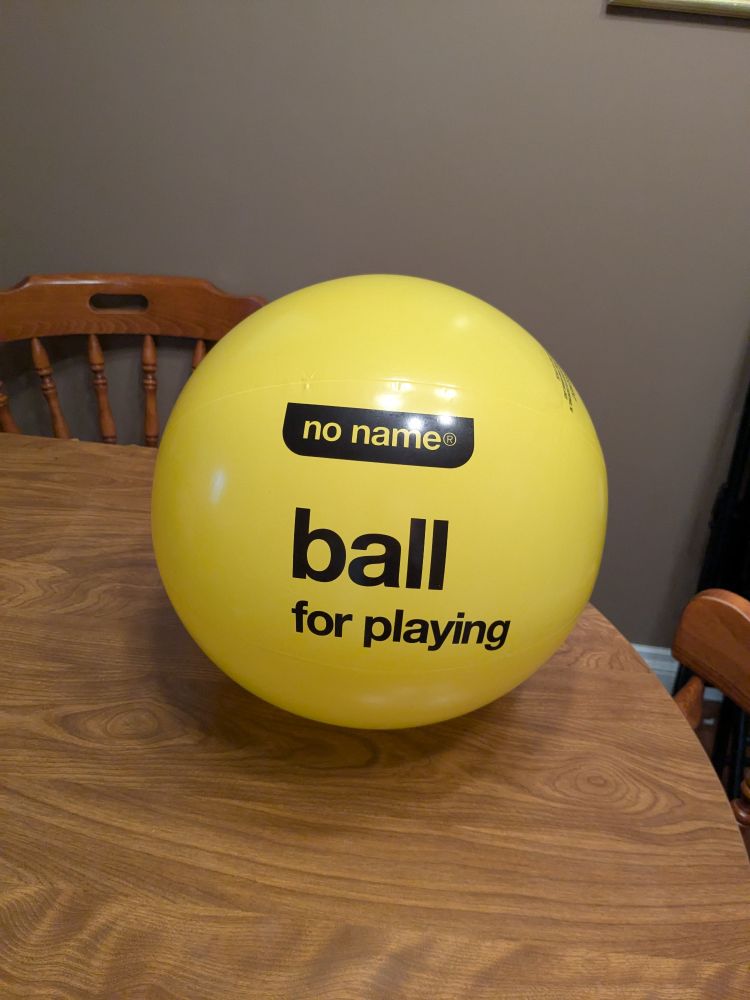 yellow beach ball labelled "ball— for playing"