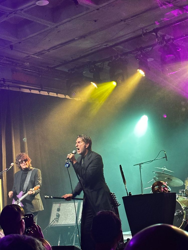 The Fixx band playing music. 