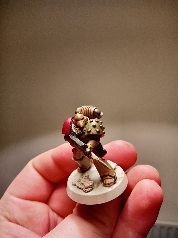 A Mark 6 marine in Death Guard livery, sporting the red arm of the Dusk Raiders to show his loyalty to the Emperor.