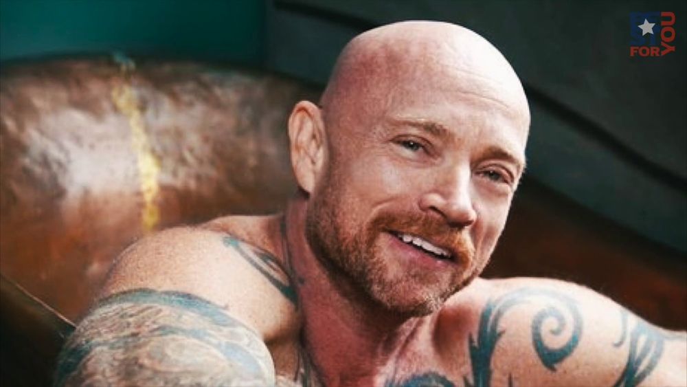 Loren Cameron. A bald bearded white man with tattoos. He was also a trans guy, a photographer, and all around cool person (as far as I know).