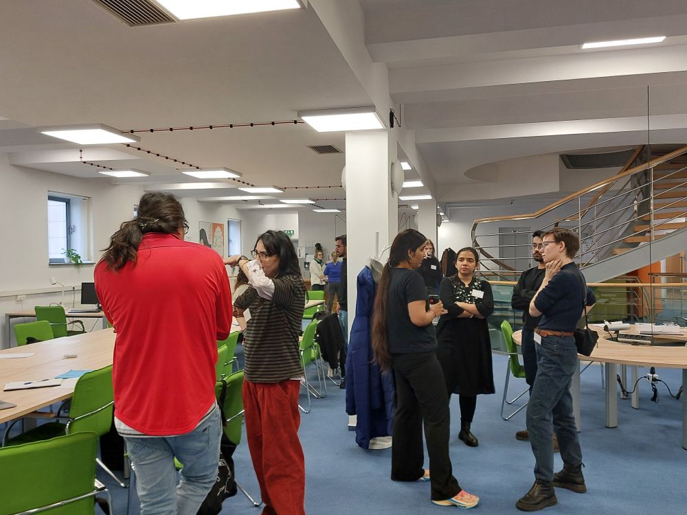 Small crowds of participants being distributed throughout the ENS Coworking Space, discussing their ideas, projects, and visions.