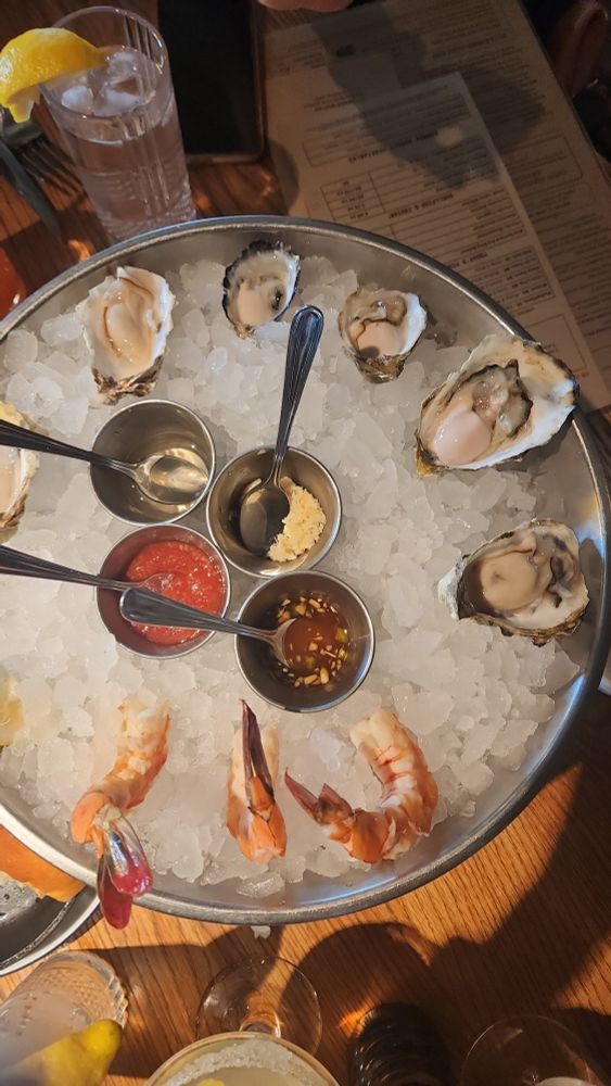 Three types of oysters two of each kind and sauces to adorn them and jumbo shrimp