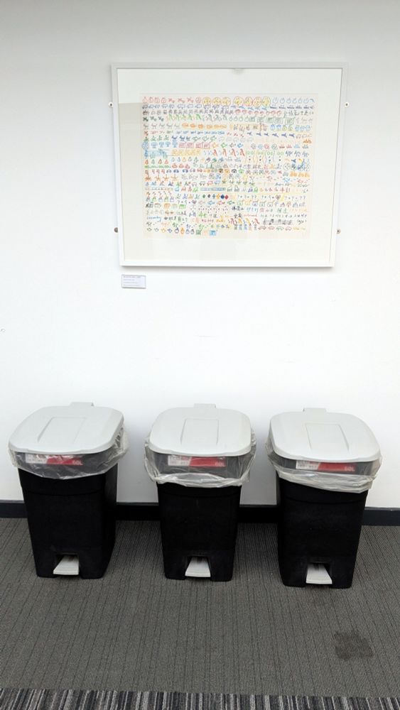 A photo of a Nam June Paik print Olympic Games (1992) in a corridor at Durham University.