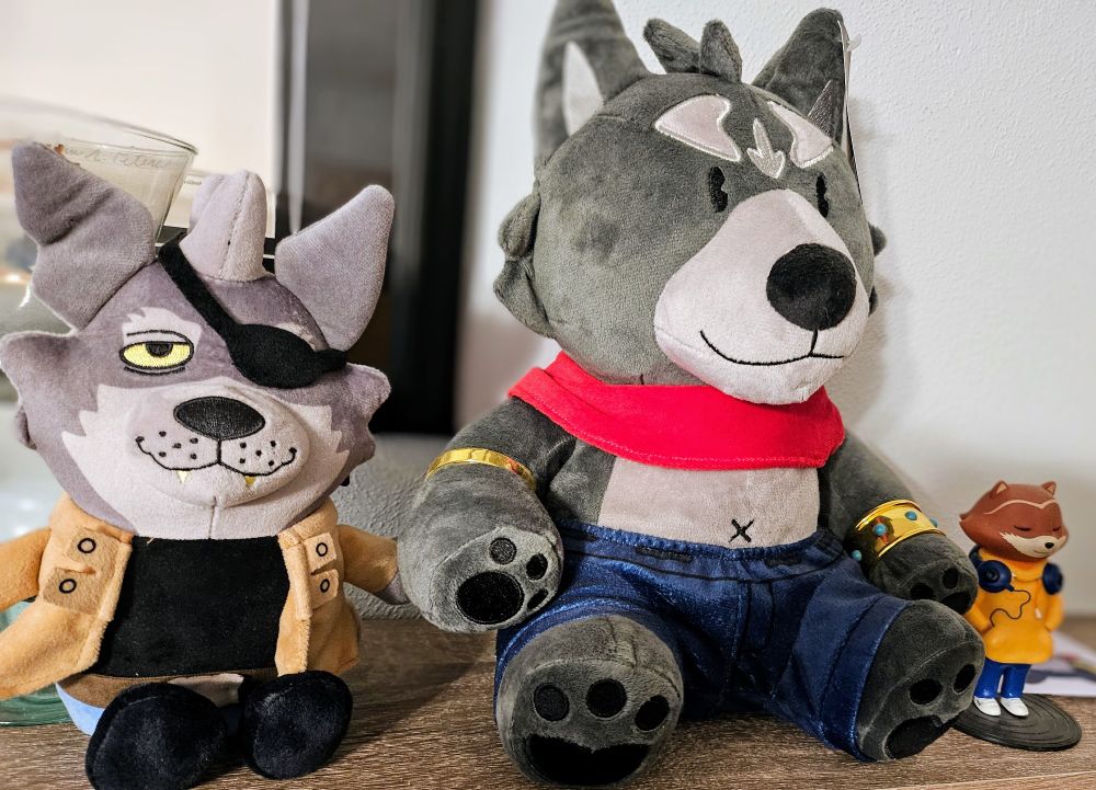 Wolf Seamus, Amicus, and the Chillhop Raccoon chilling on a shelf. 