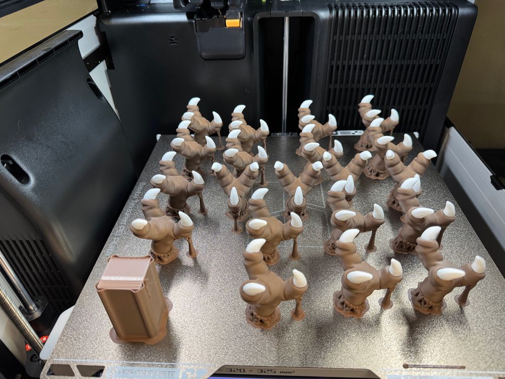 A 3D printer bed with 18 printed chocobo feet.