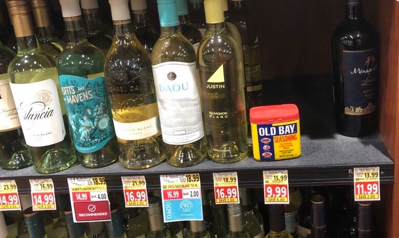 A shelf of fine wines at my grocer, with a tin of old bay left there by some merry prankster 