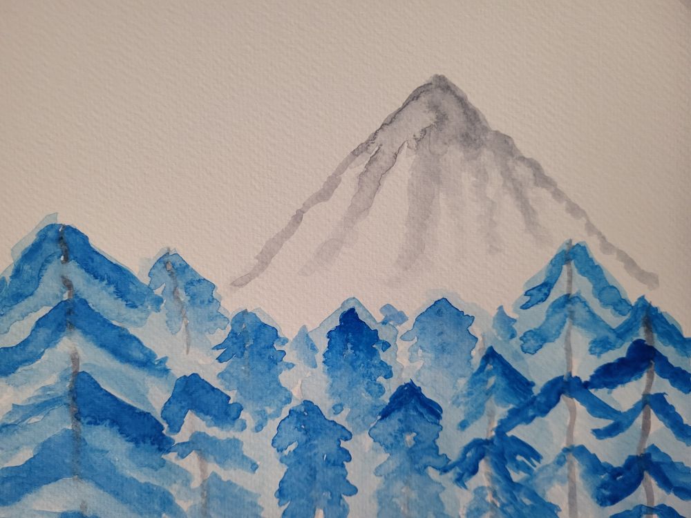watercolor painting - a gray mountain in the distance, and a forest filled with blue trees under it