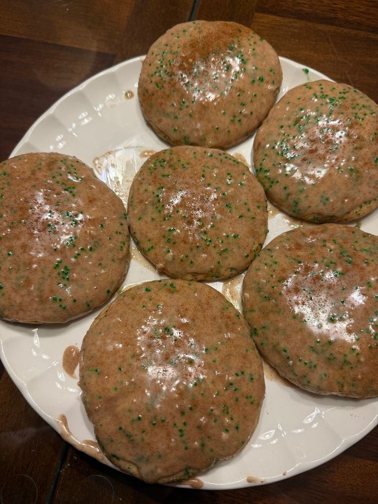 taylor swift’s chai cookies with a maple glaze and green sugar sprinkles on a white plate 