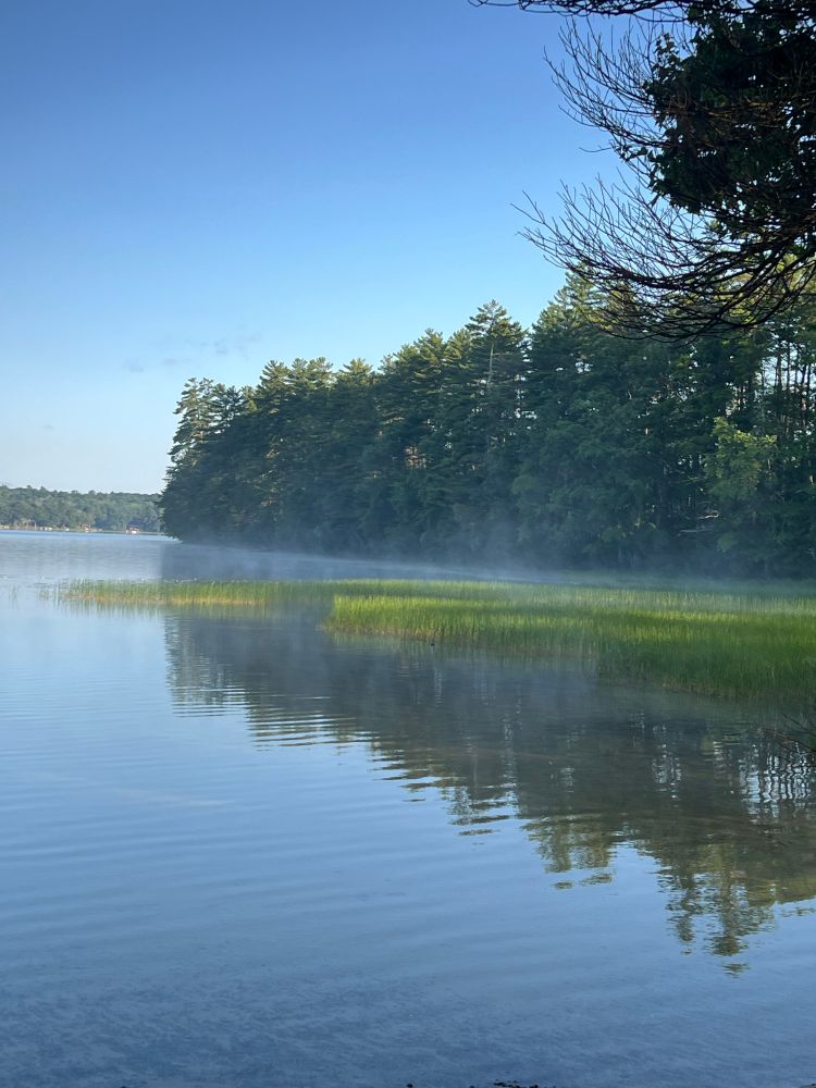 Fog remains on top of the lake in a thin layer. 