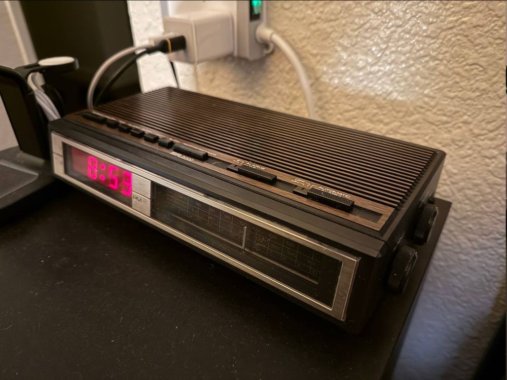A SEARS SR3000 alarm clock at 8:53PM. At least I hope cause I assumed that because it is etched "PM" by default that means PM and the red light means AM and because there is no red light on the bottom left corner next to "PM" that it is in fact PM and the red light means "AM" please let me know. Ignore the dust.