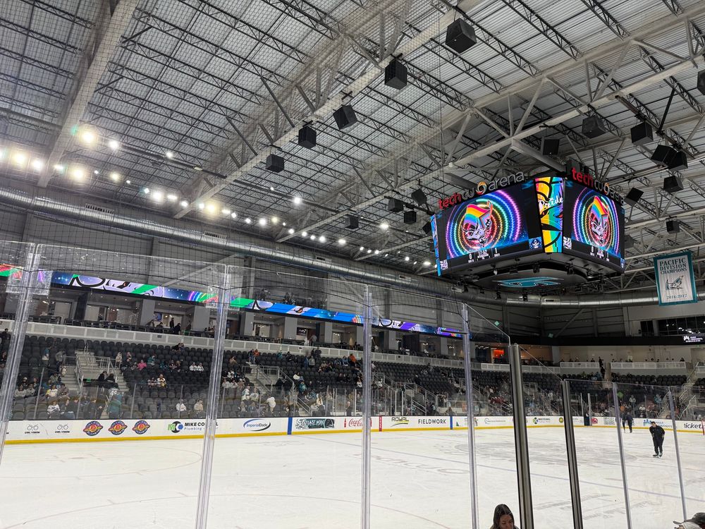 Inside the Tech CU hockey arena in San Jose, CA with some rainbow lights displays.