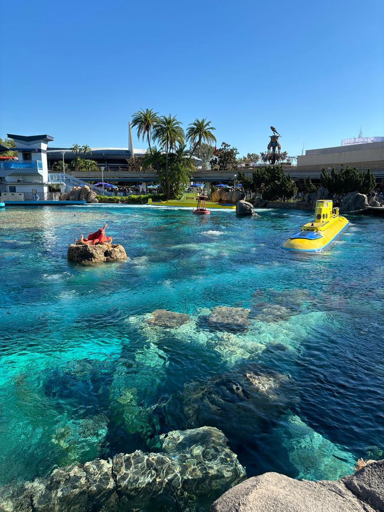 A yellow submarine is seen partially submerged under deep blue waters 