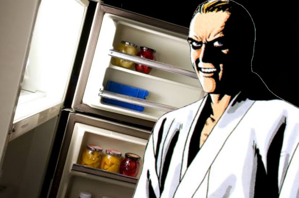 Geese howard looking at you in the dark in front of a open fridge