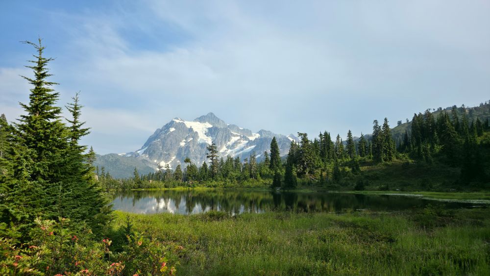 A view of Shuksan Mountain across an alpine lake. 