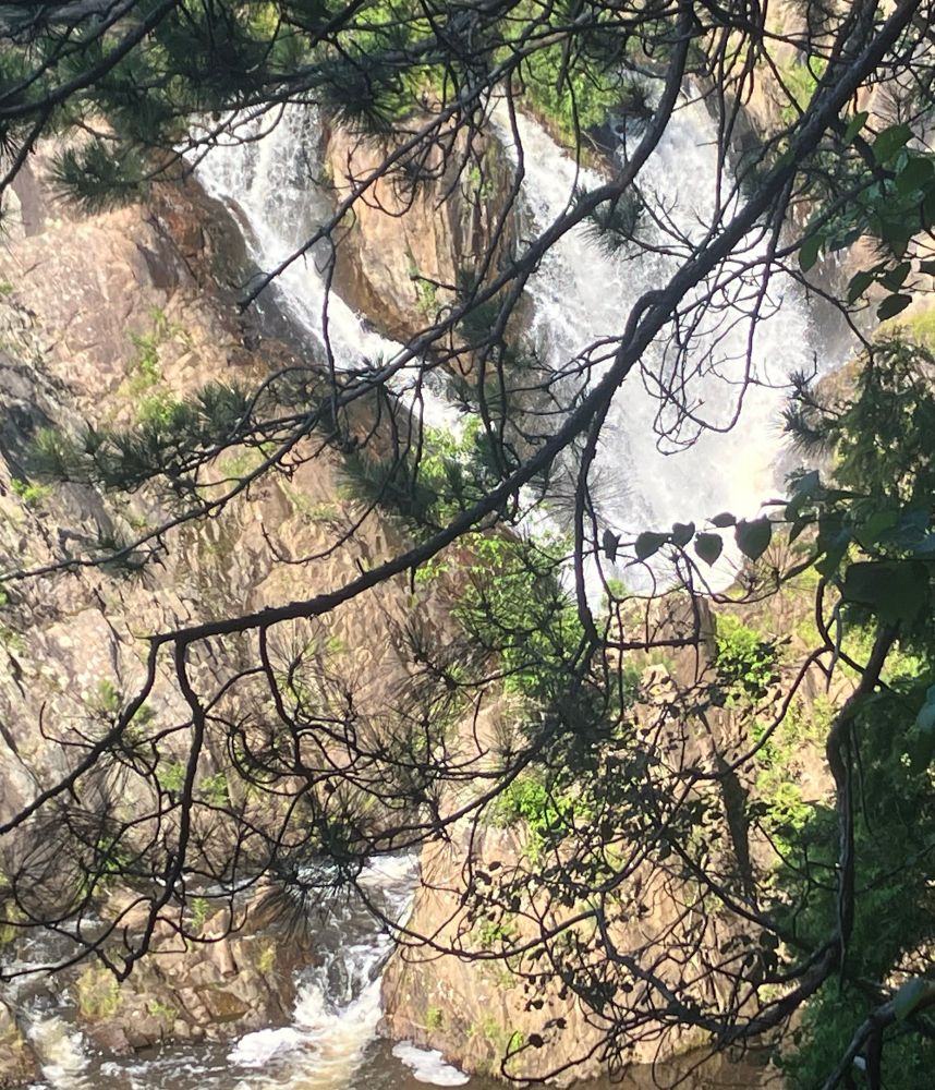 A big waterfall seen through the trees