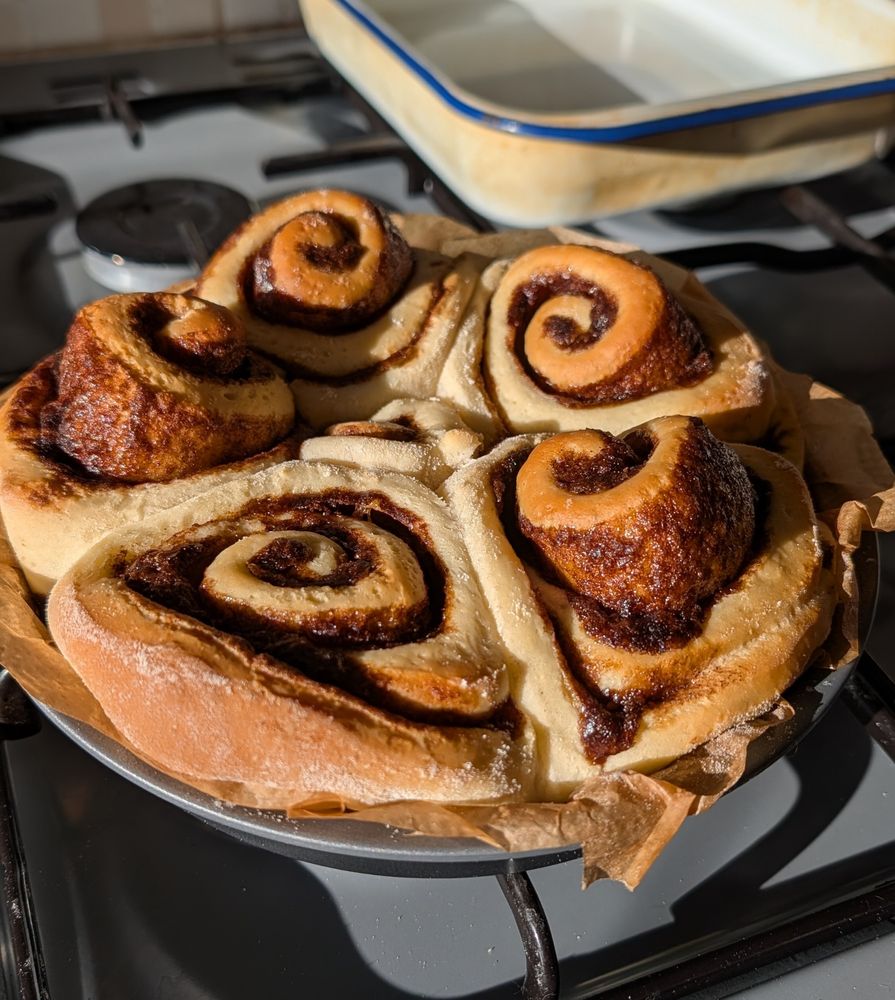freshly baked cinnamon rolls resting on the stove top