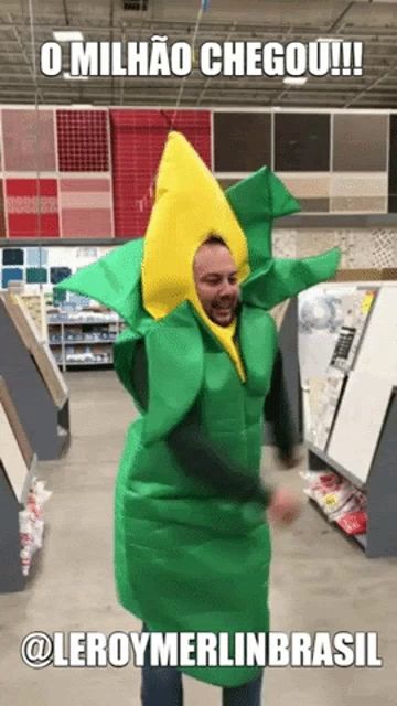 a man in a corn costume is dancing in a store with the caption " o milhao chegou "