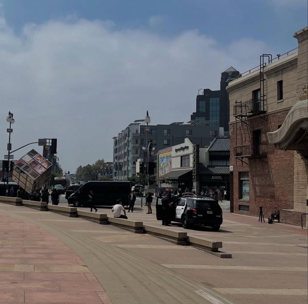 Photo of armed customs and border patrol agents and cars on the plaza in front of the Japanese American National Museum in Little Tokyo. 