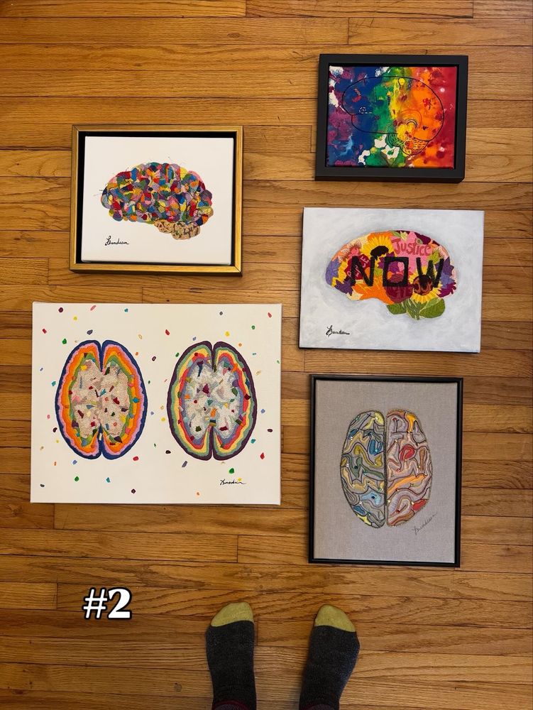 A group of five neuro art pieces all hand embroidered on the floor with stocking feet