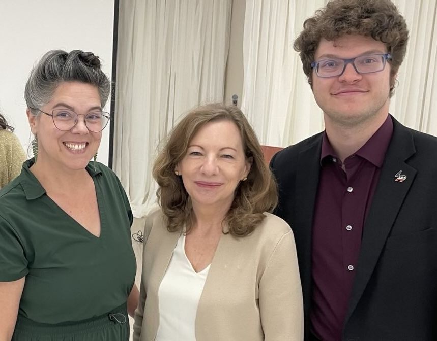 Sierra Club Oklahoma Director Kara Joy McKee in a green dress, DNC Climate Council Chair Michelle Deatrick in a cream top with beige sweater, and DNC Climate Council Western Region Advisor Ron Meehan in a black suit jacket. They stand facing the camer and smiling.