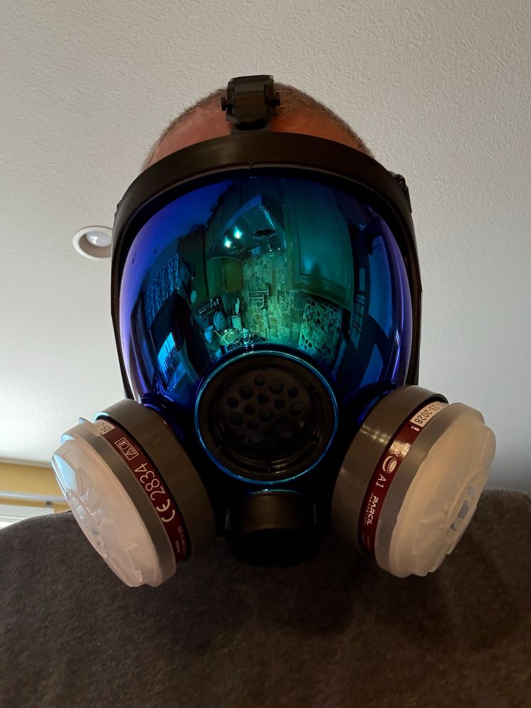 Me wearing a gas mask with a blue-mirrored face shield