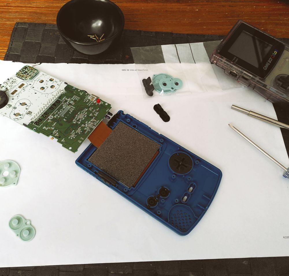 A green Gameboy Color, opened up. 
